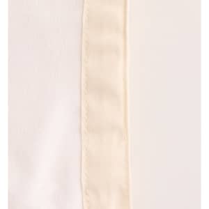 A close-up of a cream-coloured reusable linen bread bag with a textured edge and faint seam detailing.