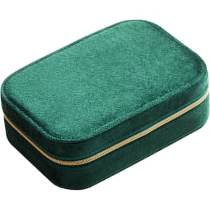 A green velvet jewellery box with a compartment and gold zipper detailing. Features a soft textured surface.