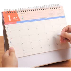 A desk calendar with a spiral binding, featuring a clean layout for January, with blue and peach accents.