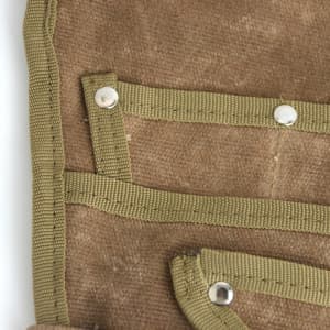 A brown garden tool waist pouch featuring multiple pockets and reinforced edges with green straps.
