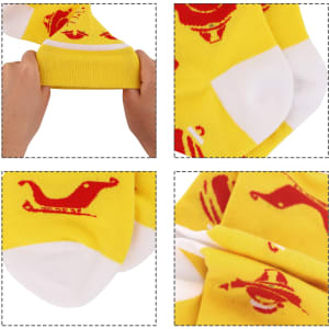 Bright yellow woven socks featuring playful red patterns, shown being stretched and folded. Includes a logo detail.