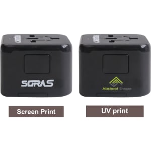 A universal travel adapter with USB-C ports in black, featuring two different print designs and a logo on each side.