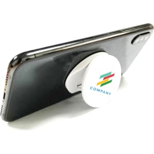 A round white phone holder attached to a smartphone, featuring a logo in multiple colours.