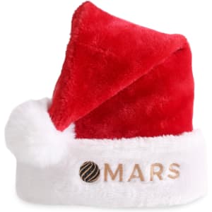 A red plush Santa hat with a white fur trim and a logo on the front.