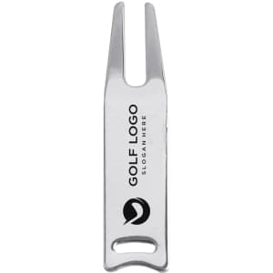 A silver golf divot tool with two prongs and a handle, featuring a logo.