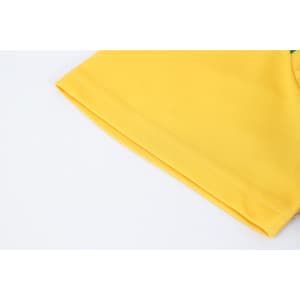 A close-up of a yellow polyester micro mesh sports long sleeve shirt, showcasing the fabric texture and sleeve detail.