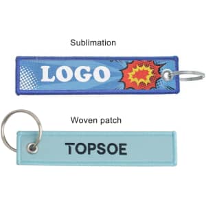 Two woven key tags in blue and light blue, each with a ring and a logo or brand name on them.