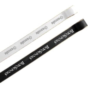 A length of ribbon in white and black, each with a gold edge and featuring a logo.
