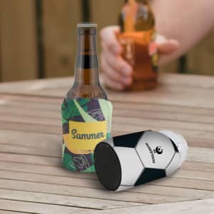 A drink bottle with a colourful stubby holder and a black and white beverage cooler on a wooden table.