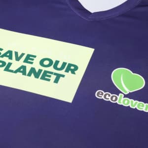 A purple V-collar tee shirt with a logo and green text promoting environmental awareness.