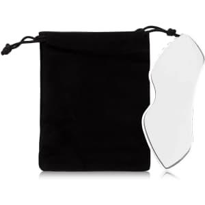 A clear Gua Sha board beside a black pouch, designed for health and beauty use.