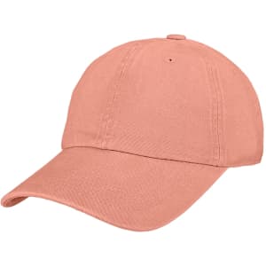 A premium washed cotton baseball cap in a soft coral colour, featuring an adjustable strap and a logo.