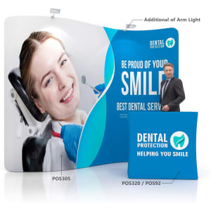 A vibrant S-shaped tension fabric display wall prominently featuring a smiling woman and a man. Includes branding elements.