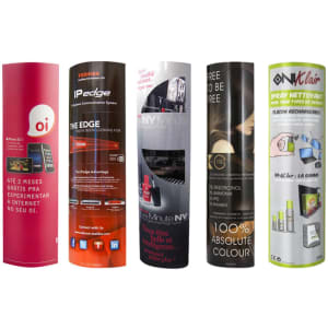 A collection of cylindrical cardboard displays in various vibrant colours, featuring logos and promotional graphics.