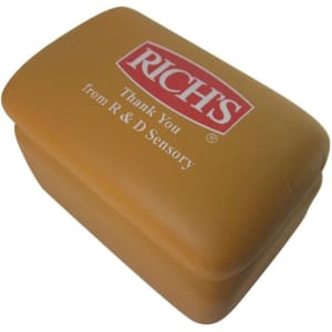 A brown toast-shaped stress reliever with a logo on the top. The product has a smooth texture and rounded edges.