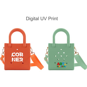 A mini beach bag in orange and green featuring cut-out holes and carrying handles. Each bag has a logo.