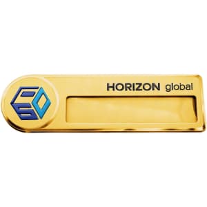 A gold metal name badge with a logo and a clear area for custom text. The design features a sleek rectangular shape.