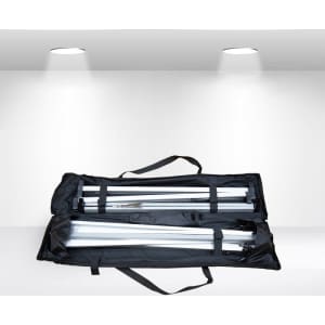 A black carrying case containing disassembled metal poles for an A-frame banner stand.