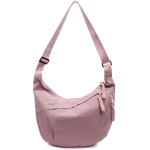 A pink crossbody bag with a curved shape, featuring a braided zipper detail and an adjustable strap.