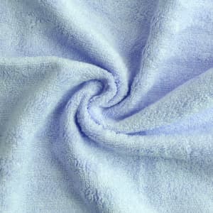 A light blue bamboo fiber towel, soft and plush, displayed in a spiralled layout, with visible texture.