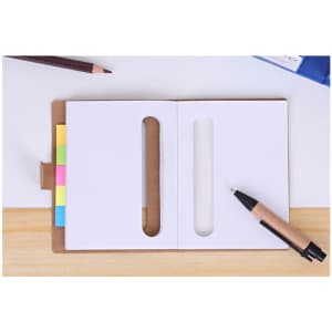 A 2 in 1 sticky notes holder in brown with colourful sticky notes, a pen, and a pencil on a clean desk surface.