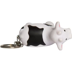 A keyring featuring a white and black cow stress reliever with a metal keychain attachment.