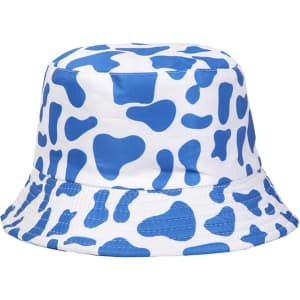 A blue and white bucket hat featuring a cow print pattern, with a branded logo on the side.