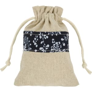 A cotton linen drawstring bag in natural and navy patchwork design with a decorative floral band.