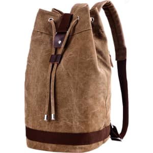 A brown canvas bucket backpack with a drawstring closure and leather accents. It features adjustable straps.
