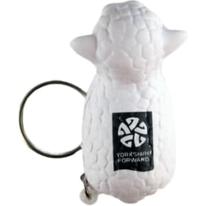 A white sheep-shaped stress reliever attached to a keyring, featuring a logo on its side.