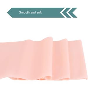 A smooth and soft pink fitness resistance band, displayed in folds, with a logo present.