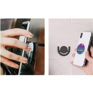 A phone pop holder in black, with a colourful circular design, attached to a smartphone and a surface.