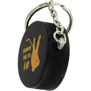 A black hockey puck stress reliever attached to a silver keyring, featuring a logo or branding.
