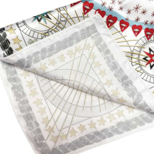 A silk satin scarf featuring a vibrant design with red hearts and star patterns on a white background.