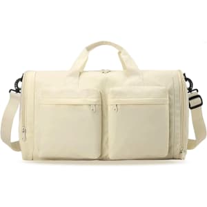A foldable travel duffle bag in cream with two front pockets and a detachable shoulder strap. Features a logo.