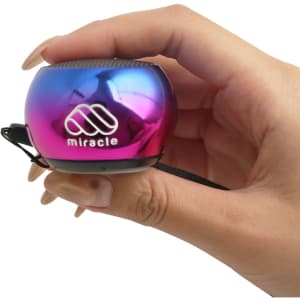 A Mini Bass Wireless Speaker in a vibrant purple and blue finish, held in a hand, featuring a logo.