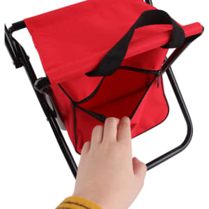 A red children's foldable camping chair with a black strap and pocket, featuring a sturdy black frame.