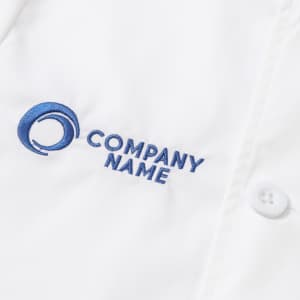 A white chef jacket with short sleeves and a double-breasted design featuring a logo and embroidered text.