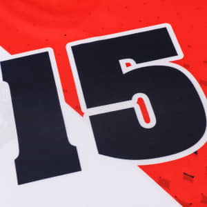 A red and white football jersey featuring a large black number 15 and a logo. Made from 100% polyester.