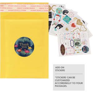 A yellow padded bubble envelope with a circular sticker and a variety of decorative stickers displayed beside it.