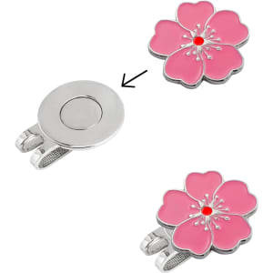 A custom soft enamel golf ball marker in pink, featuring a flower design with a silver attachment.