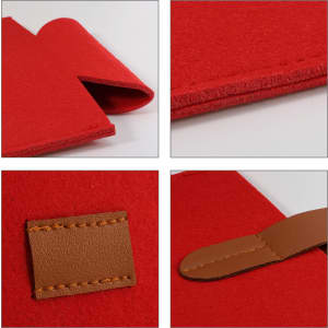 A red felt wine bag featuring a brown leather strap and stitching details, with a smooth texture and clean edges.