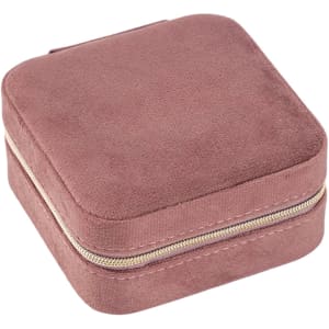 A square, soft, pink velvet jewellery organiser with a zip closure. It has a smooth, textured surface.