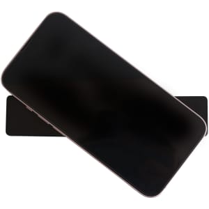 A black Sticky Nano Rubber Pad with a smartphone resting on top, showcasing a minimalist design.