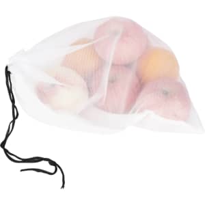 A white cotton mesh produce bag filled with various apples and oranges, secured with a black drawstring.