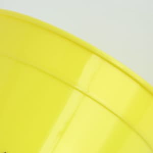 A yellow plastic stadium cup with a smooth finish and a slight curve at the rim, featuring a logo.