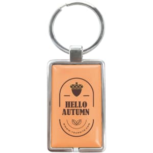 A metal keyring with a rectangular orange epoxy tag featuring an acorn design and branding.