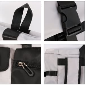 A multi-pocket roll top backpack in black and white, featuring adjustable straps and zippered compartments.