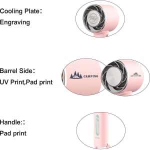 A personal cooling fan in pink with a handle, featuring engraved and printed designs on the barrel side.