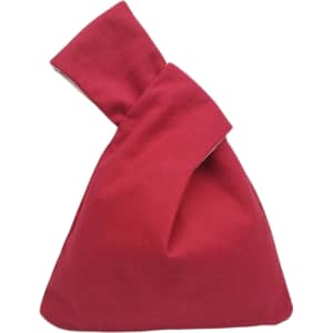 A red cotton wrist bag with a unique folded design, featuring a simple, casual appearance.
